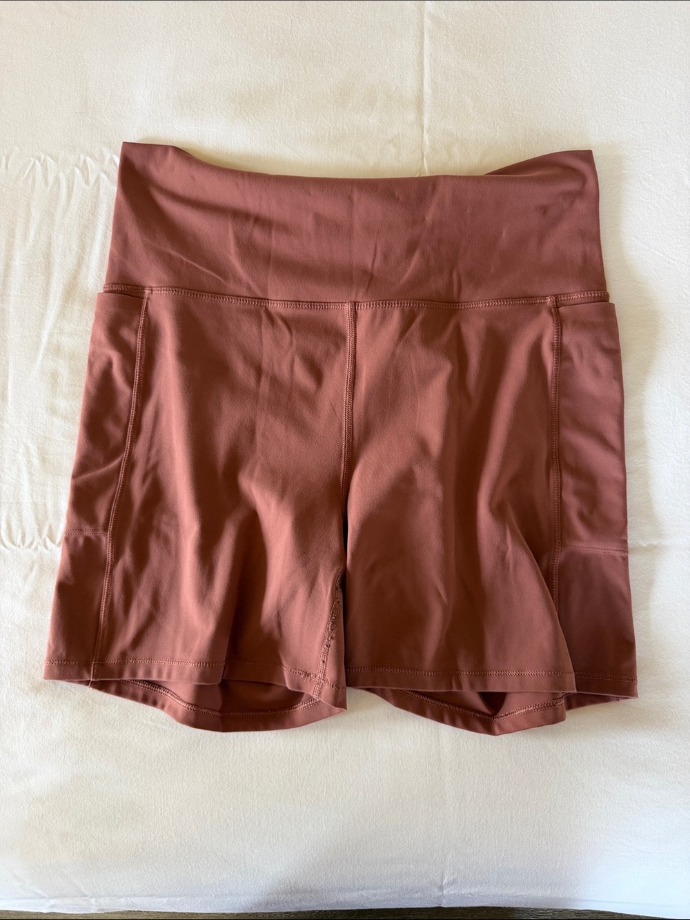 Vuori High-Rise Athletic Shorts in Rust